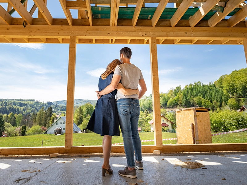 Person holding phone looking at computer